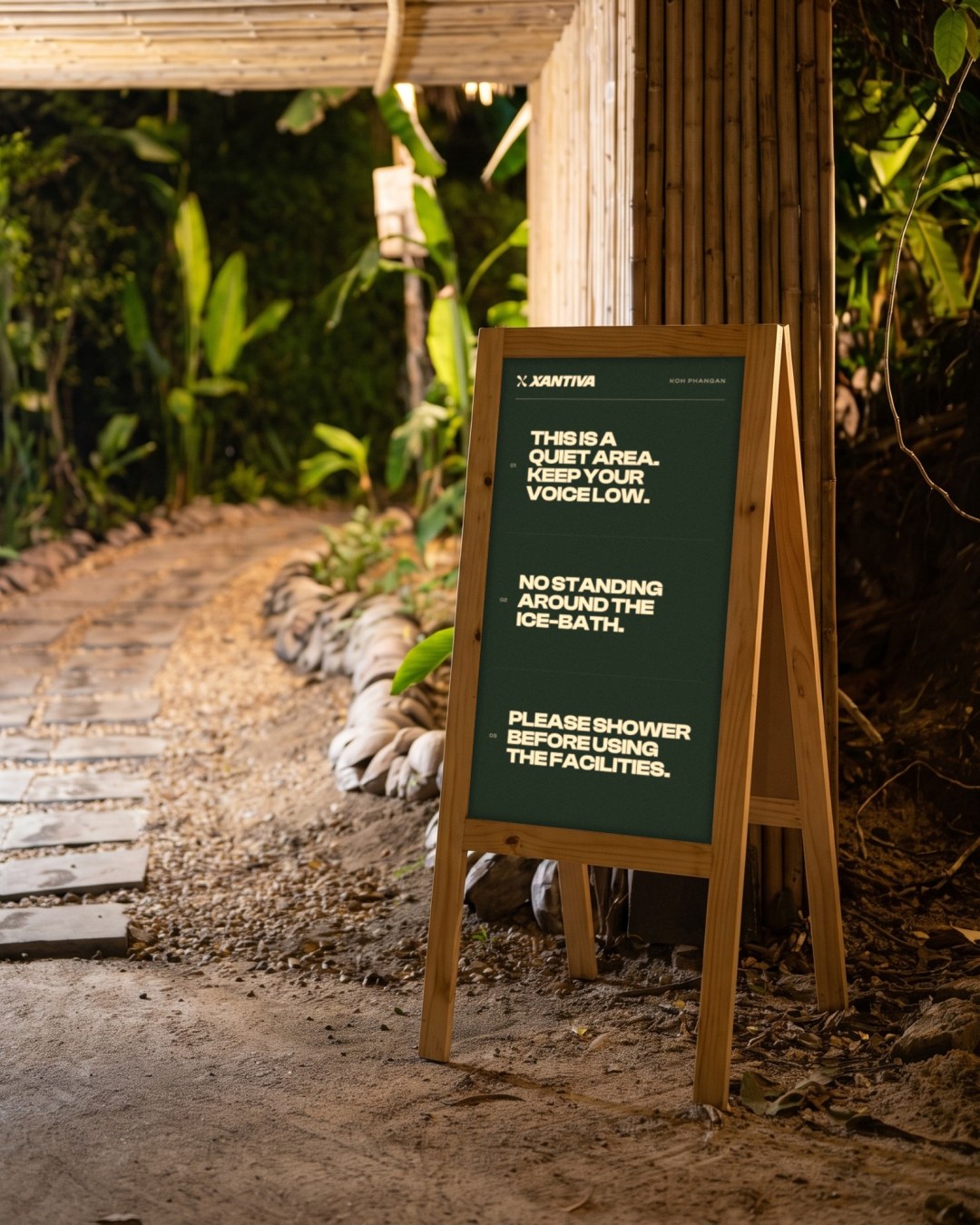 Green quiet area sign on a wooden stand at the bamboo path to the ice-bath