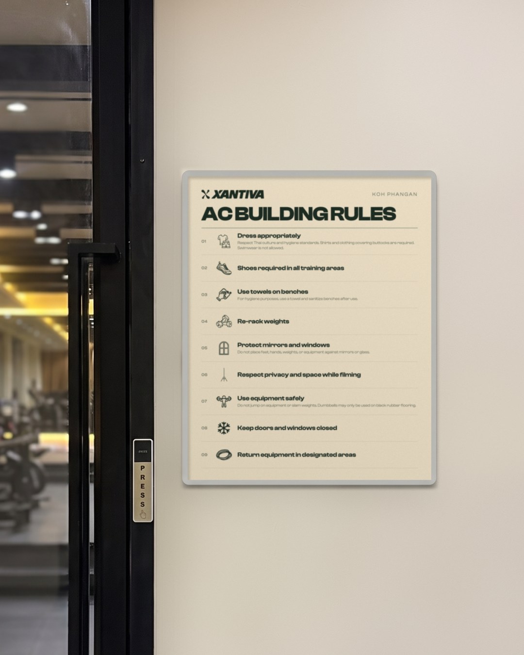 The AC building rules sign on the wall next to the gym door